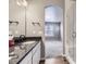 Bright bathroom featuring granite counters, sleek fixtures, and a glass-enclosed shower at 6712 Sea Oats Dr, Parker, CO 80138