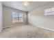 Bright, carpeted bedroom featuring large windows and ample natural light at 6712 Sea Oats Dr, Parker, CO 80138
