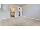 Spacious bedroom with plush carpeting and arched doorways leading to other rooms at 6712 Sea Oats Dr, Parker, CO 80138