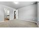Spacious primary bedroom with an archway that leads to a bathroom and a walk-in closet at 6712 Sea Oats Dr, Parker, CO 80138
