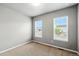 This bedroom features neutral walls, carpet, and two large windows offering ample natural light at 6712 Sea Oats Dr, Parker, CO 80138