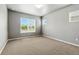 Neutral bedroom with large windows, carpeted floors, and neutral paint for a calming atmosphere at 6712 Sea Oats Dr, Parker, CO 80138