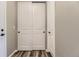 Hallway with a coat closet with white doors and black hardware plus a large closet at 6712 Sea Oats Dr, Parker, CO 80138