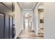 Inviting entryway featuring wood-look floors, tray ceilings, and an open floorplan at 6712 Sea Oats Dr, Parker, CO 80138