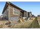 Charming home exterior featuring wood siding, stone accents, and well-maintained landscaping at 6712 Sea Oats Dr, Parker, CO 80138