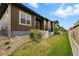 Side view of home showing neat landscaping, stairs, grass yard and neutral color scheme at 6712 Sea Oats Dr, Parker, CO 80138