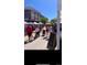 Local farmers market with tents, various food and craft vendors and people walking around at 6712 Sea Oats Dr, Parker, CO 80138