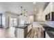 Open-concept kitchen with stainless appliances, granite island, and seamless flow to the living area at 6712 Sea Oats Dr, Parker, CO 80138