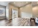 Bright living room with sliding glass doors, wood floors and modern light fixture at 6712 Sea Oats Dr, Parker, CO 80138