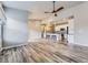 Open concept living room and kitchen with wood-look floors and modern lighting at 6712 Sea Oats Dr, Parker, CO 80138