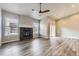 Bright living room with fireplace, wood-look floors, and sliding glass doors to the yard at 6712 Sea Oats Dr, Parker, CO 80138