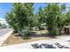 A spacious backyard, enclosed with chain link and wooden fences and shaded by mature trees at 1900 Kingston St, Aurora, CO 80010