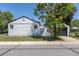 View of home and detached garage from the backyard, showing mature trees at 1900 Kingston St, Aurora, CO 80010