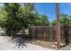 The wooden fence provides privacy for the spacious backyard with mature trees at 1900 Kingston St, Aurora, CO 80010