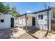 White home with a covered patio area and access to a detached garage at 1900 Kingston St, Aurora, CO 80010