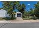View of home, backyard and detached garage from the street with mature trees at 1900 Kingston St, Aurora, CO 80010