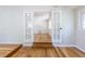 Living room featuring hardwood floors, brick accent walls and a French door at 1900 Kingston St, Aurora, CO 80010