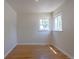 Sunny bedroom featuring hardwood floors and bright double windows at 1900 Kingston St, Aurora, CO 80010