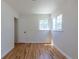 Light-filled bedroom featuring hardwood floors, a large window and a door at 1900 Kingston St, Aurora, CO 80010