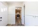 Open entryway with wood-look flooring and view of the kitchen with stainless appliances at 1900 Kingston St, Aurora, CO 80010