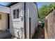 View of the side of the home showcasing the siding and utility hook ups at 1900 Kingston St, Aurora, CO 80010
