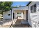 Back exterior of the home with cover to detached garage and covered patio at 1900 Kingston St, Aurora, CO 80010