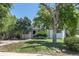 Attractive single-story home featuring mature trees, a lush lawn, and a neatly paved driveway at 1900 Kingston St, Aurora, CO 80010
