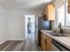 Spacious kitchen featuring stainless steel appliances, wood cabinets and updated flooring at 1900 Kingston St, Aurora, CO 80010