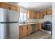 Updated kitchen with stainless steel appliances, classic wooden cabinets, and modern flooring at 1900 Kingston St, Aurora, CO 80010