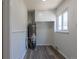 Utility room features wood look floors, storage cabinets and modern water heater at 1900 Kingston St, Aurora, CO 80010