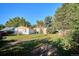 A spacious grassy yard with mature trees and a shed offers privacy and plenty of room to enjoy at 7735 Westview Dr, Lakewood, CO 80214