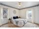 Bright bedroom with a ceiling fan, two windows and a comfortable bed at 7735 Westview Dr, Lakewood, CO 80214