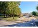 Well-maintained front yard with ample parking and mature trees at 7735 Westview Dr, Lakewood, CO 80214