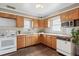 Efficient kitchen with ample cabinet space and bright white appliances at 7735 Westview Dr, Lakewood, CO 80214
