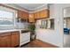 Well-lit kitchen with lots of storage and an adjacent open dining area at 7735 Westview Dr, Lakewood, CO 80214