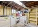 Unfinished laundry room with washer, dryer and a freezer at 7735 Westview Dr, Lakewood, CO 80214