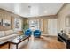 Bright living room features hardwood floors and large windows at 7735 Westview Dr, Lakewood, CO 80214