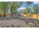 Expansive backyard featuring a wood fence and mature trees, offering a private and spacious area for outdoor activities at 10472 Lincoln Ct, Northglenn, CO 80233