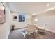 A basement office space provides a quiet workspace with natural light from a well window and simple decor at 10472 Lincoln Ct, Northglenn, CO 80233