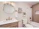 Well-lit bathroom featuring a modern vanity, gold fixtures, decorative shelves, and a shower-tub combination for an appealing space at 10472 Lincoln Ct, Northglenn, CO 80233