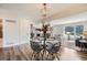 Open-concept dining area featuring modern light fixture, seating for four and access to the kitchen and living room at 10472 Lincoln Ct, Northglenn, CO 80233