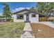 Charming single-story home featuring a landscaped front yard, covered porch, and updated exterior paint at 10472 Lincoln Ct, Northglenn, CO 80233
