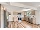 Bright kitchen boasts stainless steel appliances, modern cabinets and countertops, recessed lighting, and hardwood floors at 10472 Lincoln Ct, Northglenn, CO 80233
