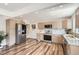 Bright kitchen boasts stainless steel appliances, modern cabinets and countertops, recessed lighting, and hardwood floors at 10472 Lincoln Ct, Northglenn, CO 80233