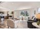 Spacious living room flows into an open kitchen, featuring hardwood floors and natural light at 10472 Lincoln Ct, Northglenn, CO 80233