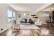 Bright living room flows into dining, featuring hardwood floors, recessed lighting, and modern decor at 10472 Lincoln Ct, Northglenn, CO 80233