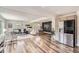 Open concept living space with hardwood floors, modern light fixtures and stainless steel appliances at 10472 Lincoln Ct, Northglenn, CO 80233