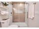 Elegant shower with glass door, built-in shelving, and modern fixtures at 10472 Lincoln Ct, Northglenn, CO 80233