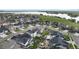 Aerial view of a neighborhood with well-maintained homes, landscaping, and a lake in the background at 6614 S Vandriver Way, Aurora, CO 80016