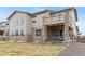 Backyard exterior showcasing a patio and walkout balcony with stone pillars at 6614 S Vandriver Way, Aurora, CO 80016